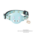 Pink adjustable cat collar with built-in white Apple AirTag protective case on a table.