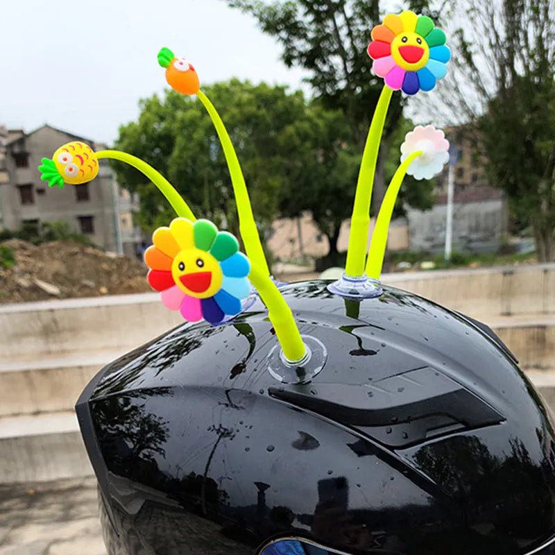 Yellow silicone swinging sunflower decoration with suction cup for helmet attachment.