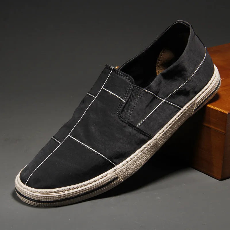 Men's low-top slip-on canvas shoes in multiple colours on a flat rubber sole with a square heel.