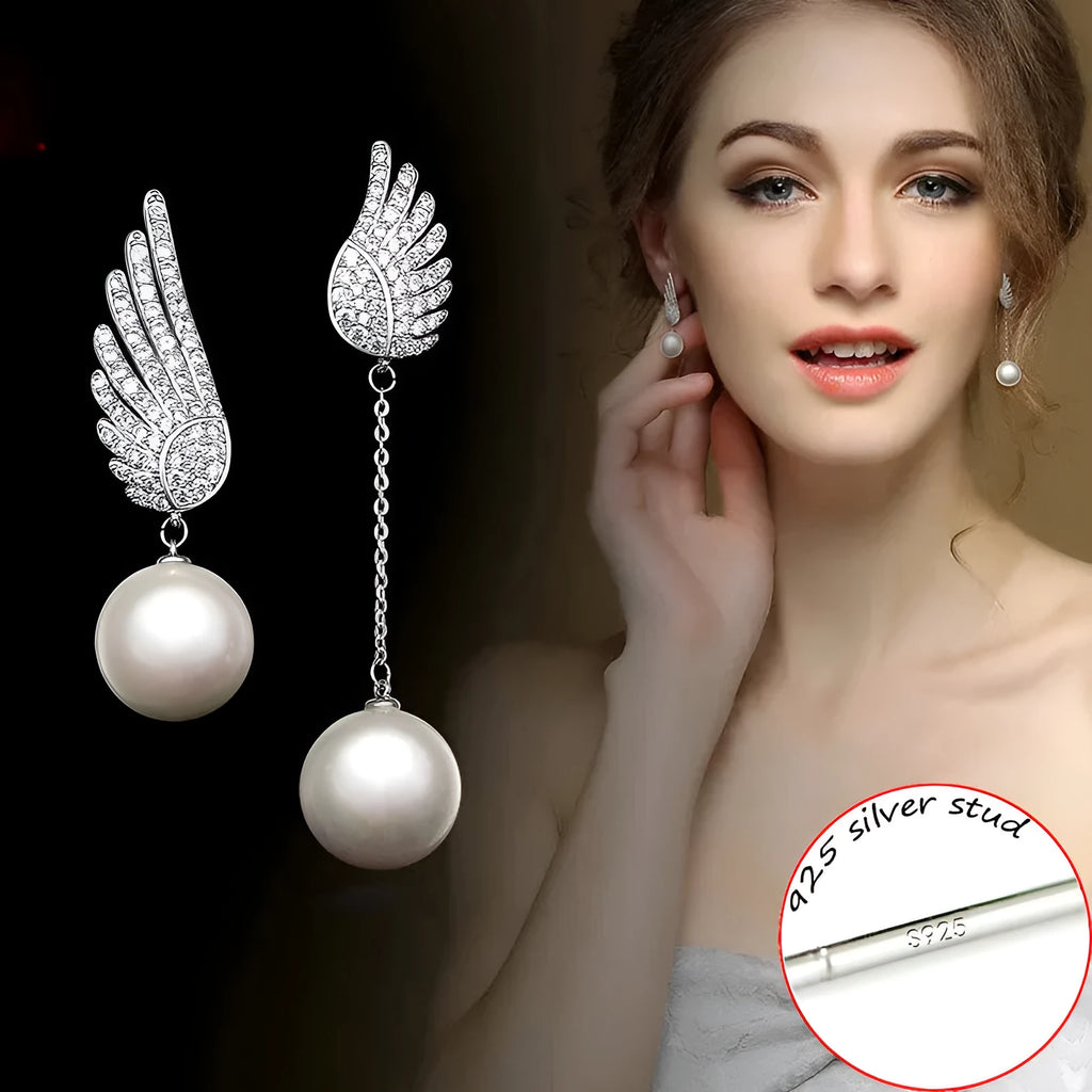 Sterling silver angel wing drop earrings with gold-plated stone inlay and diamond-cut texture.
