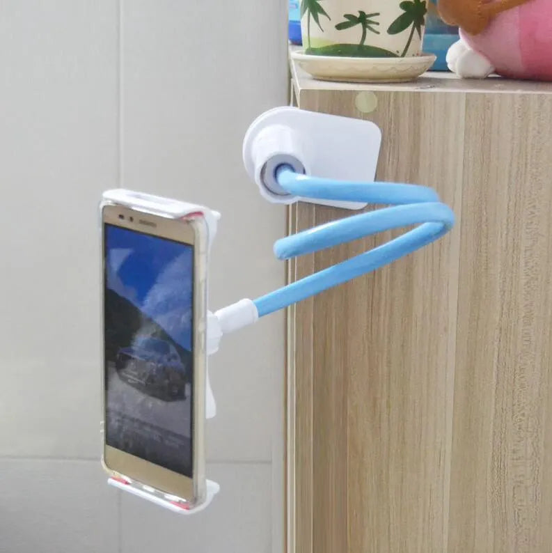 Black bedside phone handset with long adjustable arm and clamp base on a wooden table.