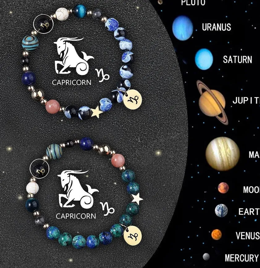 Two natural stone beaded bracelets with sterling silver zodiac charms on a wooden surface.