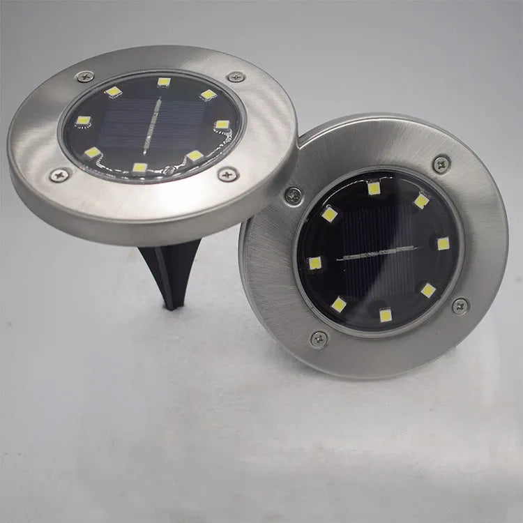 8LED waterproof solar garden light with IP65 protection and warm LED glow on lawn