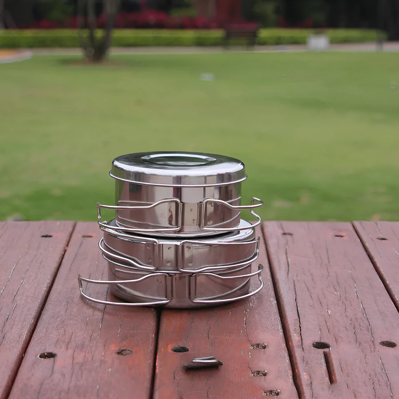 Silver stainless steel camping cookware set with four pieces for outdoor cooking