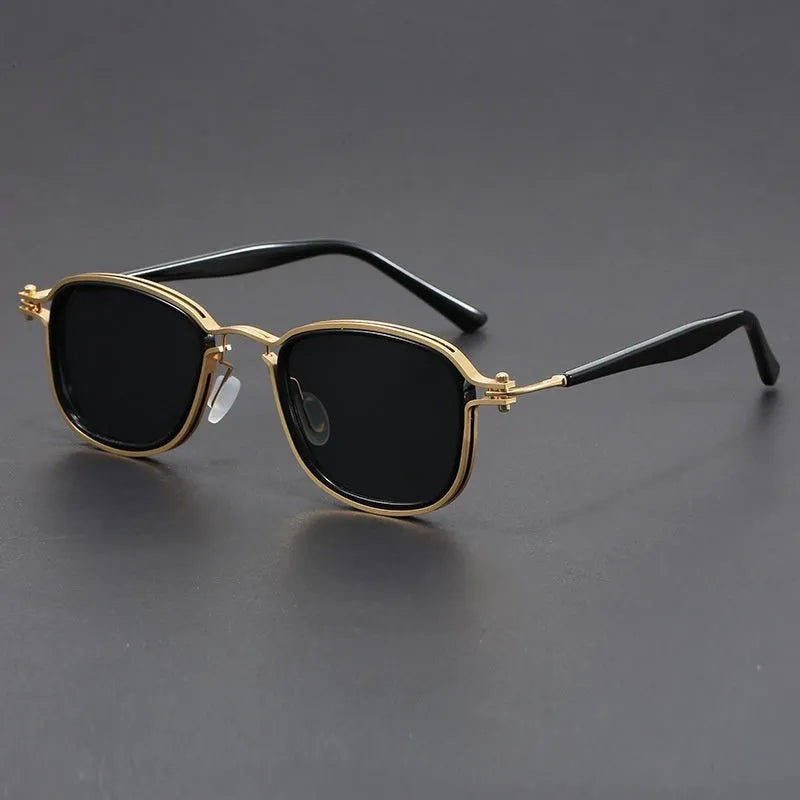 Retro square sunglasses with metal frame and tinted AC lenses in a two-tone colour option on a wooden surface.