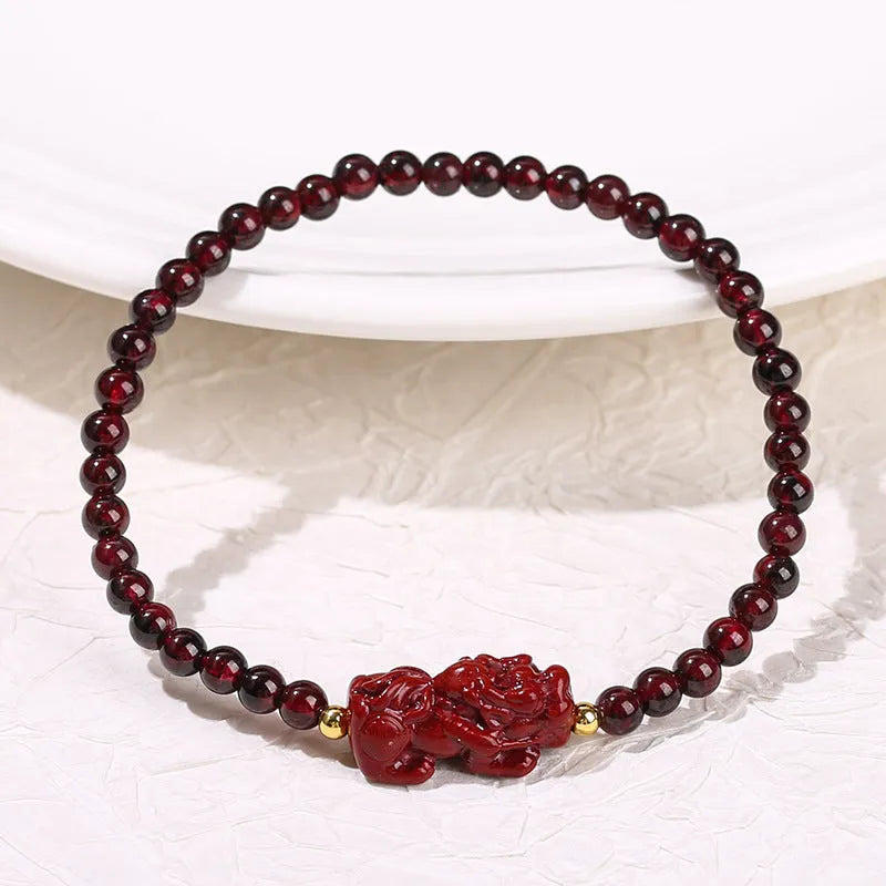 Geometric square garnet bracelet with carved purple pixiu charm on wrist