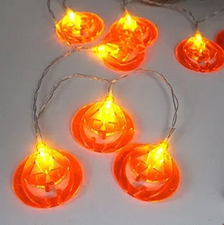 Halloween LED string lights with pumpkin, bat, and ghost decorations hanging on a wall
