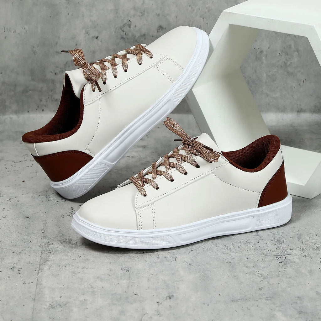 Beige brown platform skateboard sneakers with a cross-strap and round toe on a white background.