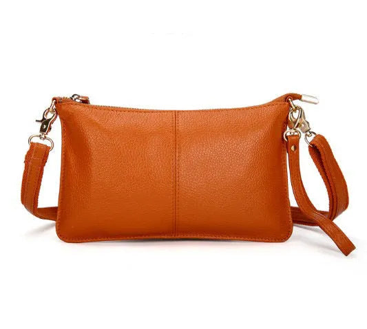 A cowhide lady slant bag in a chosen colour, showing hand and shoulder straps, with dimensions of 24 cm by 14 cm.