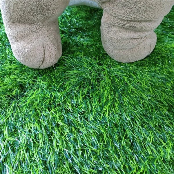 Green washable dog grass pee training mat with realistic lawn texture on a patio.