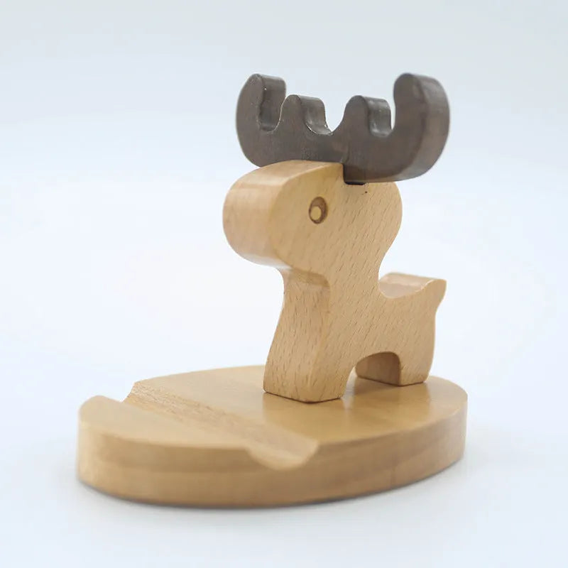 Sculpted beech wood lazy bracket phone holder with custom engraved text on a wooden desk.