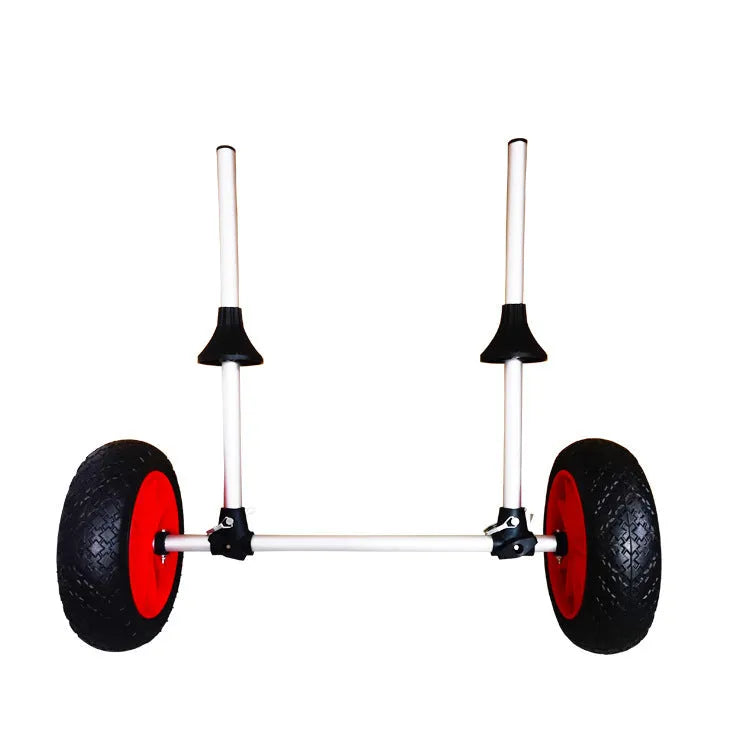 Foldable aluminium kayak handcart with rubber cradle, shown carrying an open kayak on a beach.