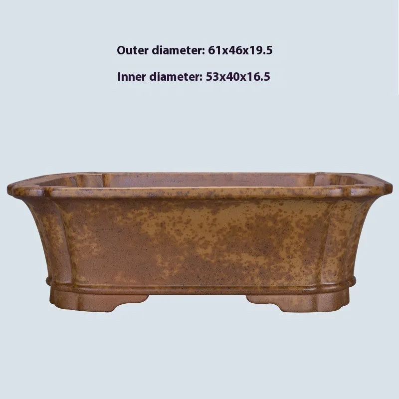 Hand-thrown rectangular purple sand flower pot with dual drainage holes on a wooden deck.