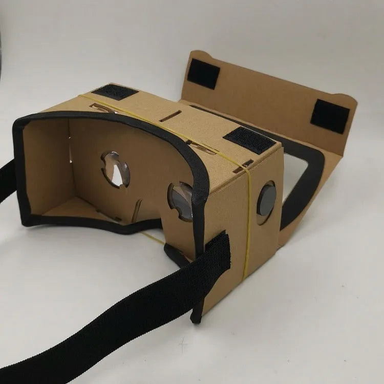 Pink and white flat-pack cardboard VR glasses viewer for smartphones with 3D lenses and straps.