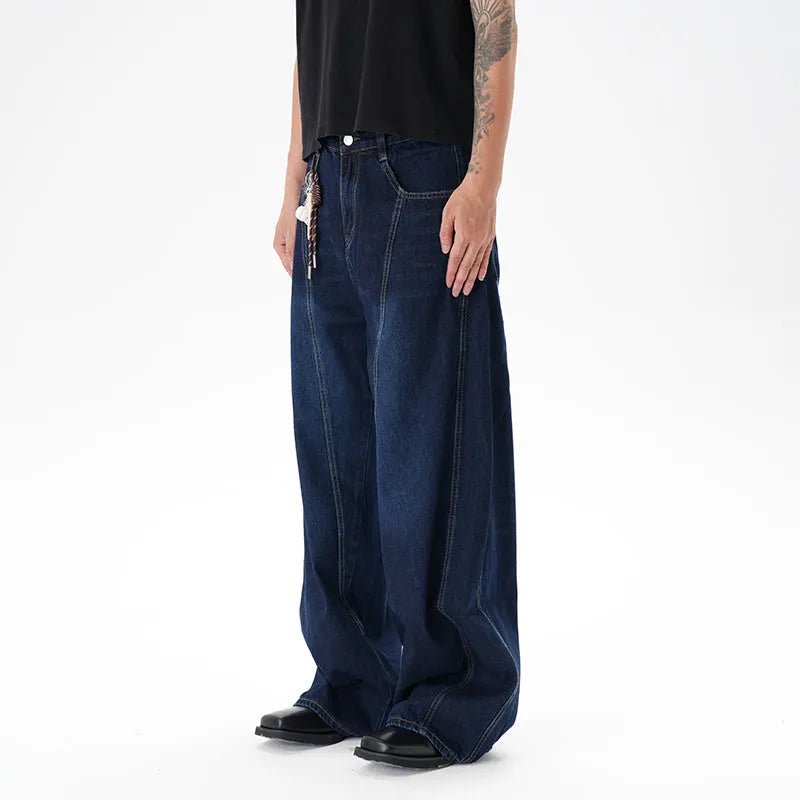 Dark blue washed distressed wide leg machete jeans showing denim fabric texture and wide leg silhouette