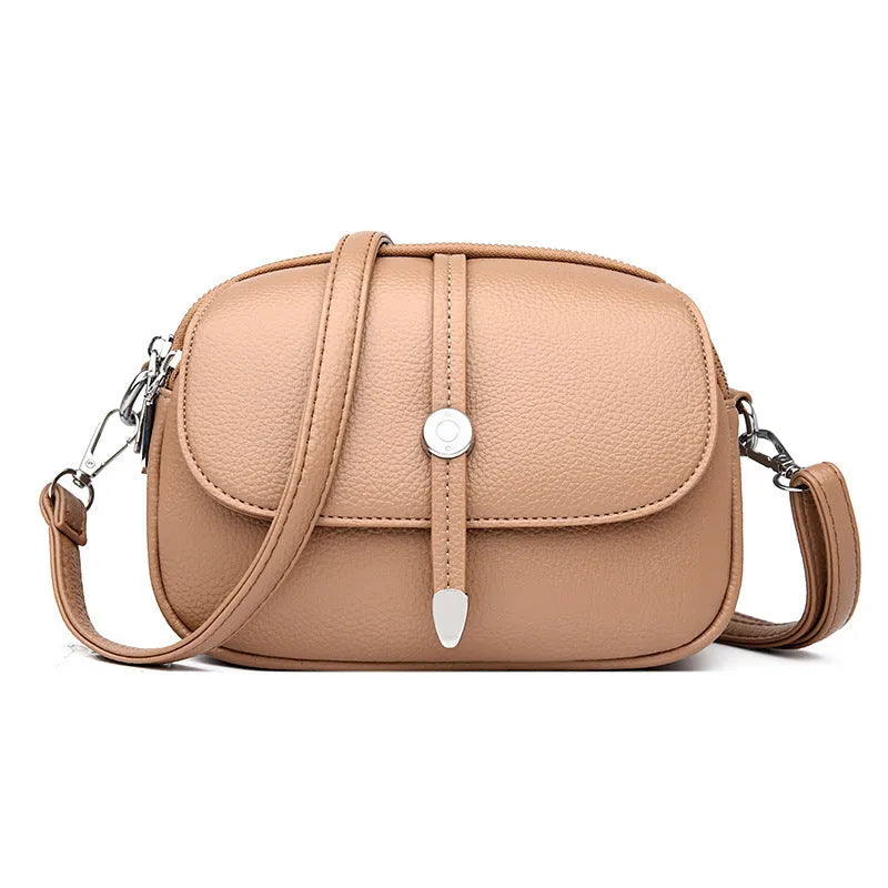 Women's soft PU crossbody shoulder bag with oval suitcase shape in black, khaki, or dark brown