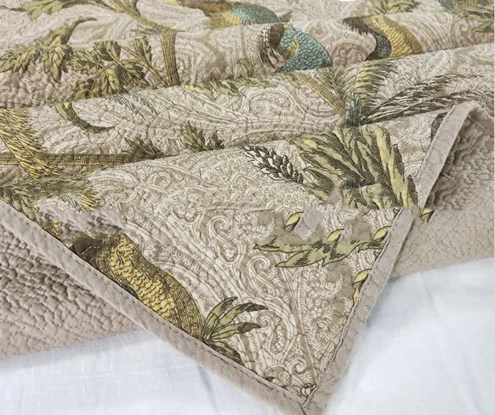 Blue American floral and bird pattern quilted cotton bedspread set on a bed, showing detailed stitching and 230x250cm size.