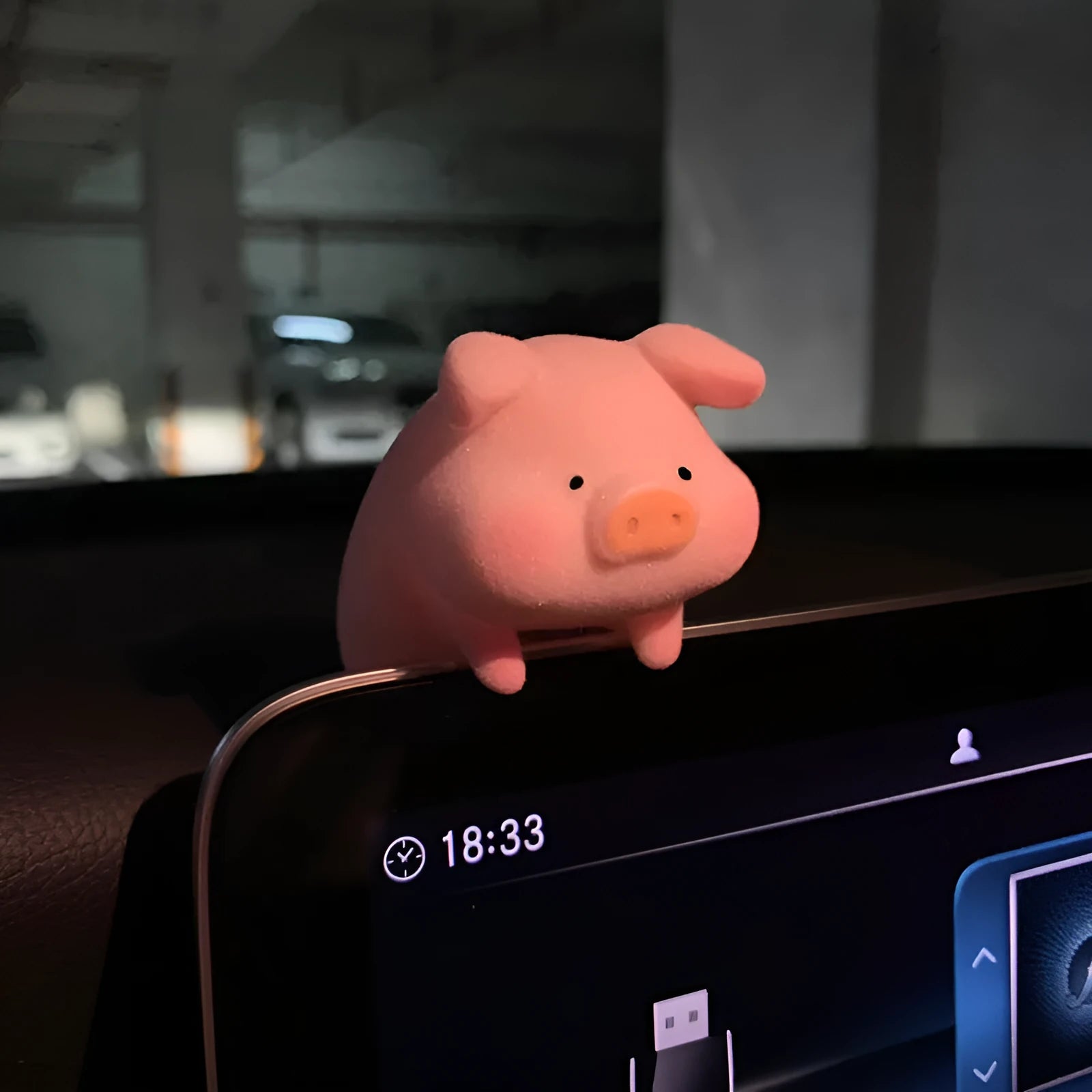 A hard resin cartoon pig car dashboard ornament in one of eight available decorative styles.