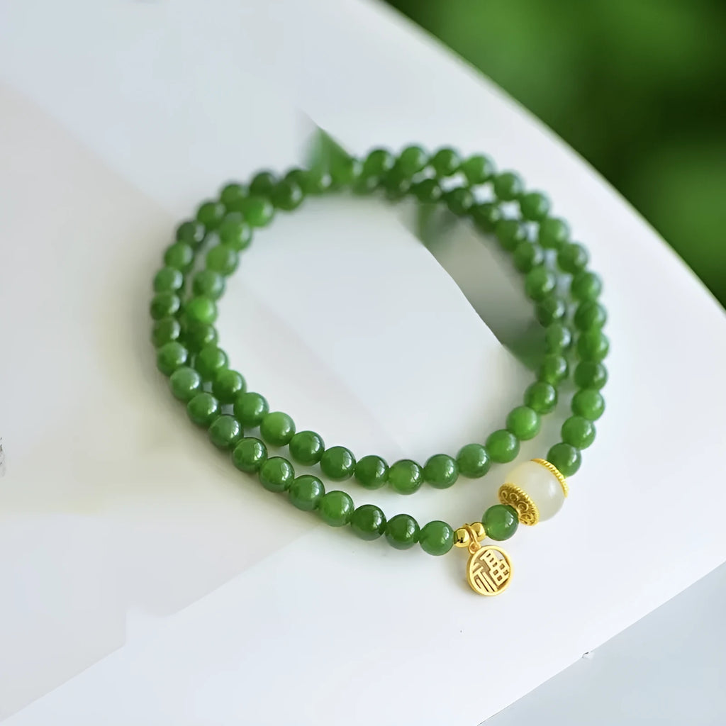 Women's double circle bracelet made from natural Hetian Jade, showing geometric shape and fu character detail.