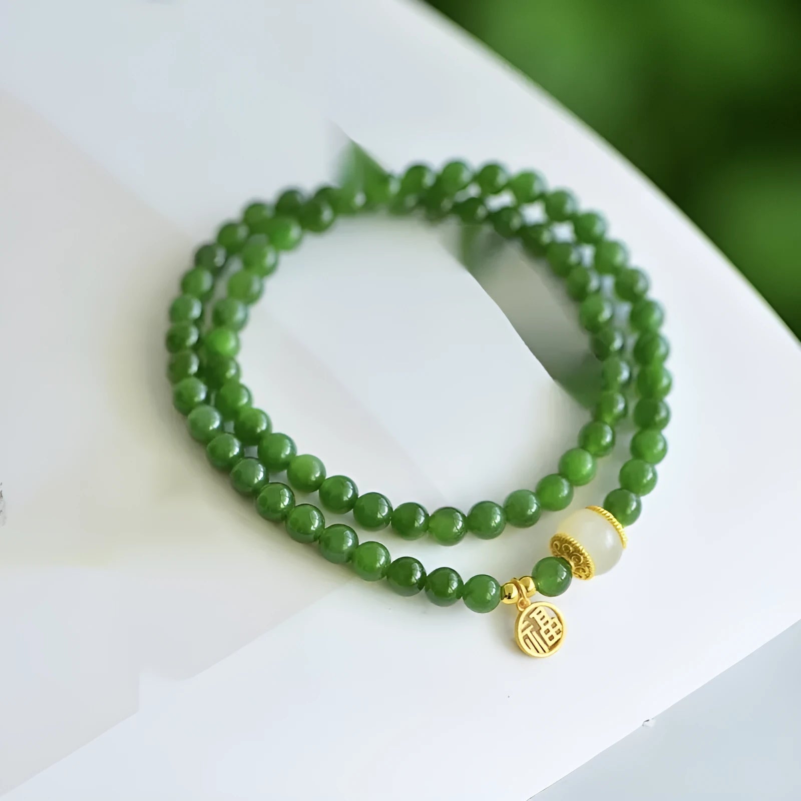 Women's double circle bracelet made from natural Hetian Jade, showing geometric shape and fu character detail.