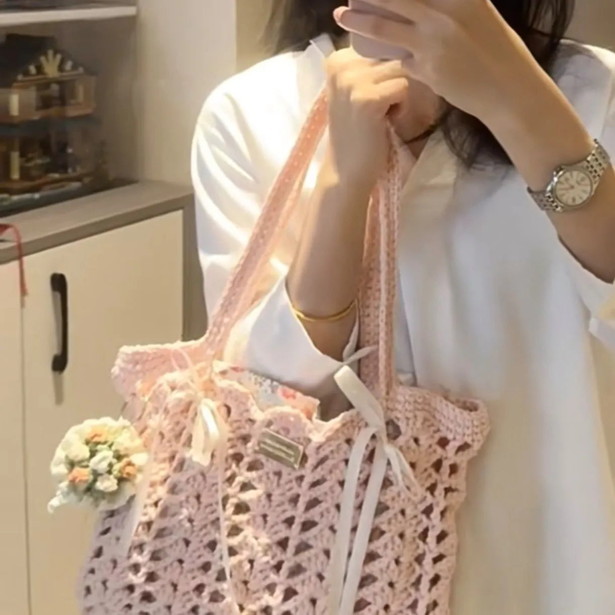 Handwoven wool summer tote bag with a floral patterned design.