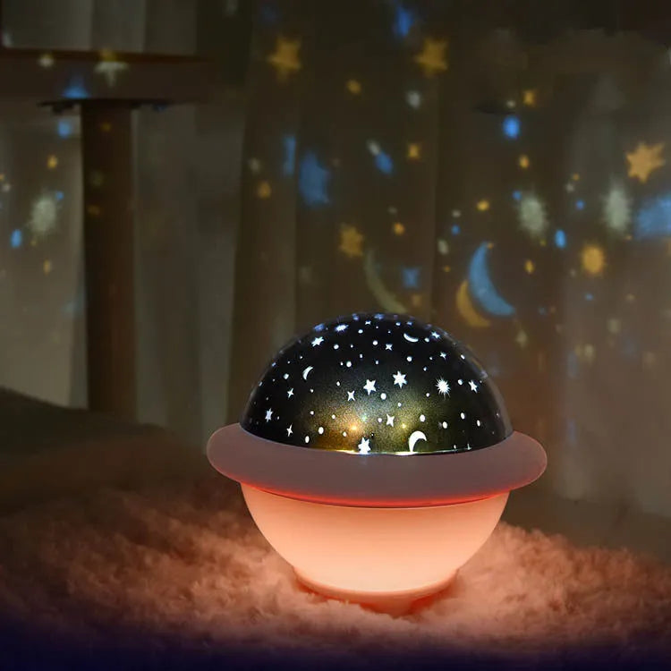 UFO-shaped plastic starry sky projection night light in green, pink or white colour.