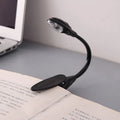 Mini clip-on LED book light with 26cm total length and metal clip on a book page