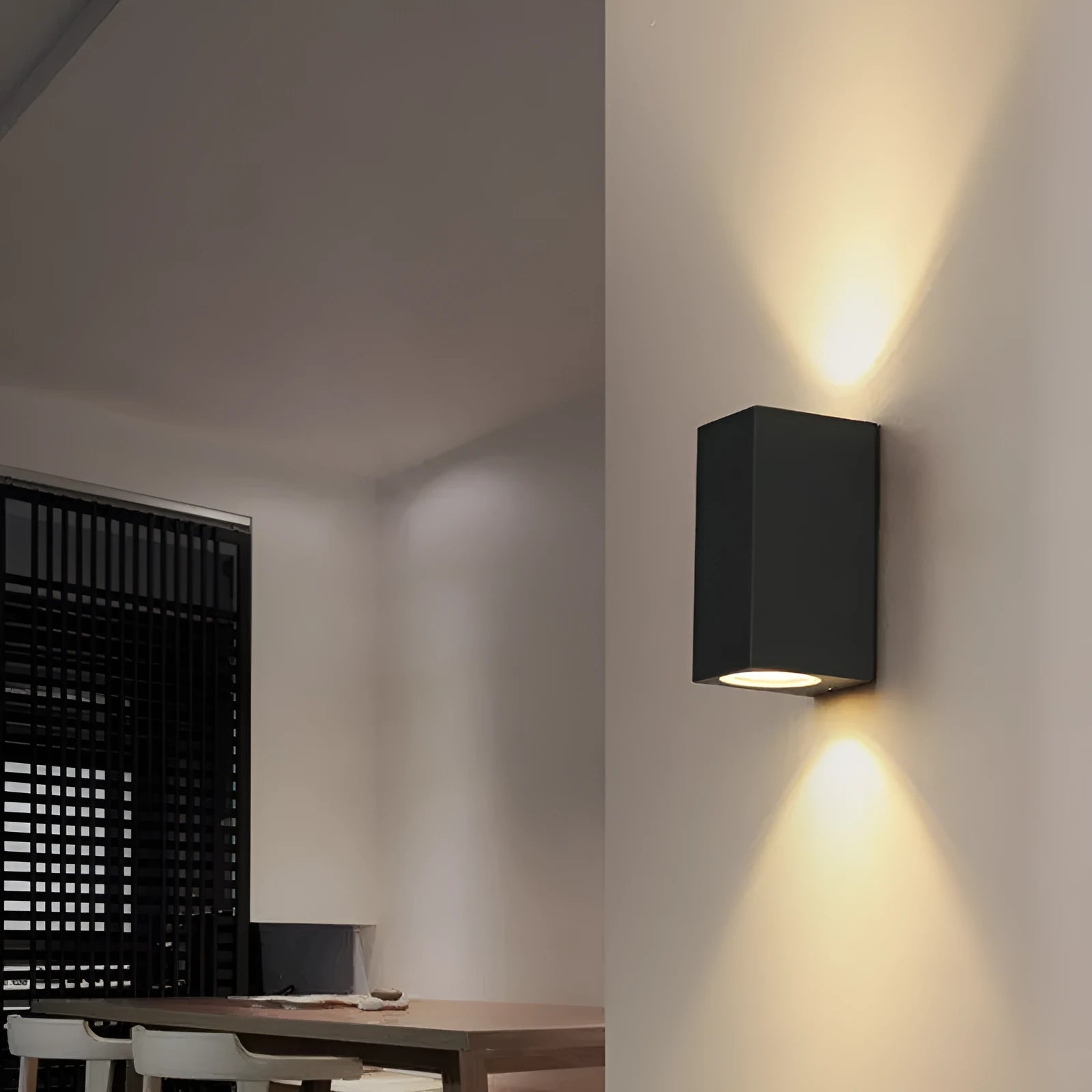 Modern black aluminium LED wall lamp with glass shade and silicone rubber trim.