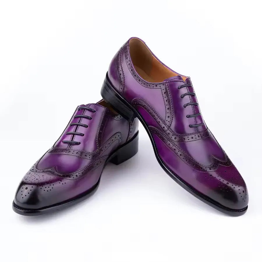 Men's purple leather Oxford dress shoes with hand-carved detailing and pointed toe on a rubber sole.