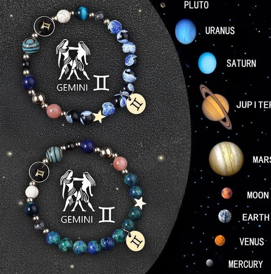 Two natural stone beaded bracelets with sterling silver zodiac charms on a wooden surface.