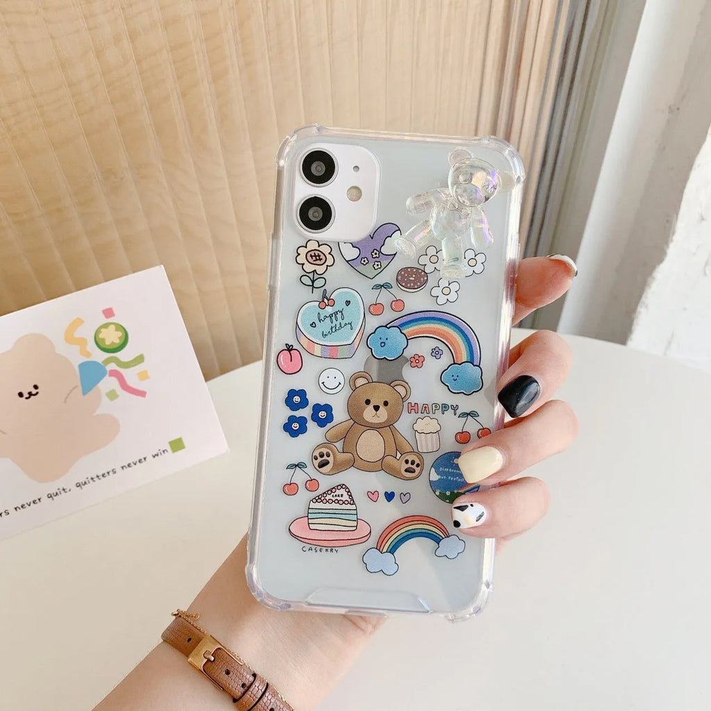 White TPU iPhone case with an attached silver bear pendant on a chain, showing cartoon-style design.