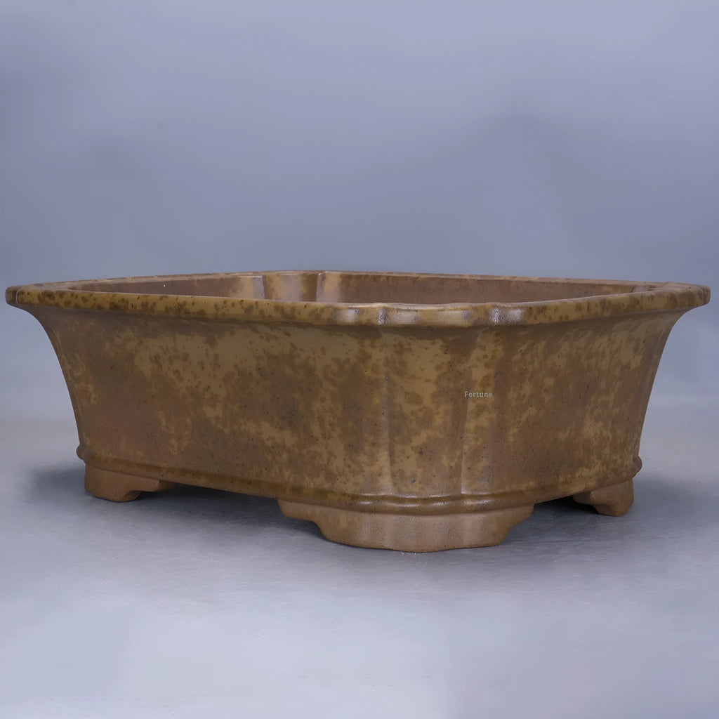 Hand-thrown rectangular purple sand flower pot with dual drainage holes on a wooden deck.