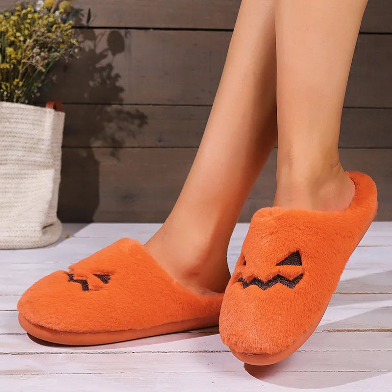 Orange Halloween pumpkin-themed plush indoor slippers with a non-slip PVC sole.