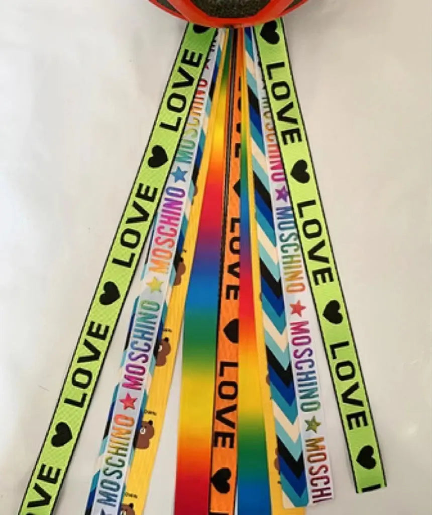 A decorative ribbon streamer for attaching to a child's roller skate or ski helmet, shown in a selection of colours.