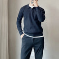 Man wearing a loose grey modal knit pullover sweater with a textured rabbit fur blend fabric.