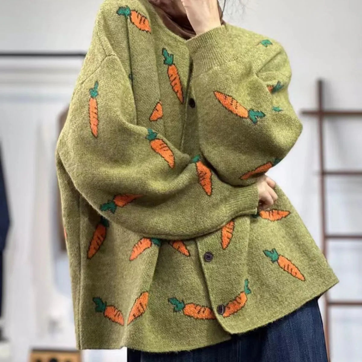 Loose grey cardigan with artistic colour-block printing, round neck, and regular sleeves.
