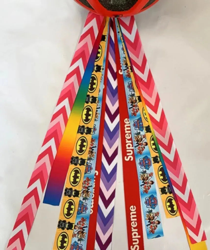 A decorative ribbon streamer for attaching to a child's roller skate or ski helmet, shown in a selection of colours.