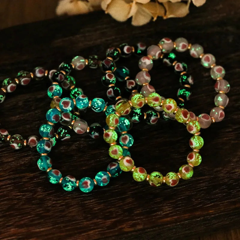 Handmade glass bracelet with swallowing gold beast design on heart-shaped 10mm beads