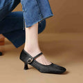 Black women's square toe stiletto ankle-strap heels with horse hair upper and buckle closure.