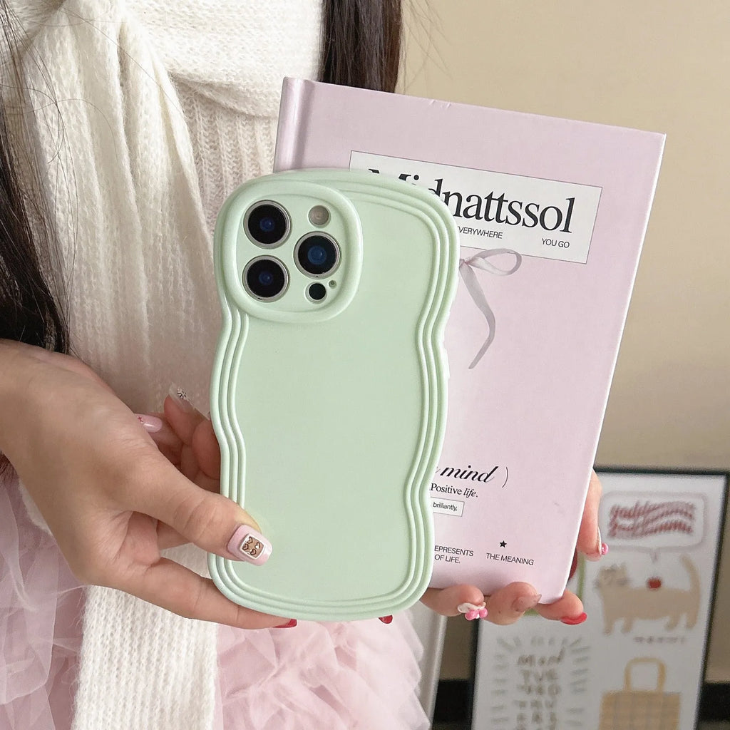 Cream coloured wave texture mobile phone case for iPhone on wooden surface