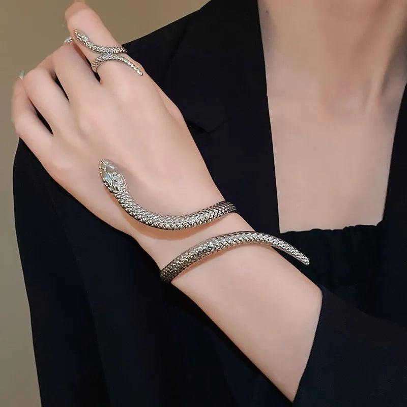 Gold metal snake-inspired ring and bracelet set with exaggerated twisted winding design