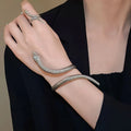 Gold metal snake-inspired ring and bracelet set with exaggerated twisted winding design
