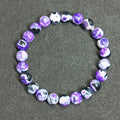 Close-up of a ladies bohemian bracelet with 8mm round glass beads in natural agate colours.