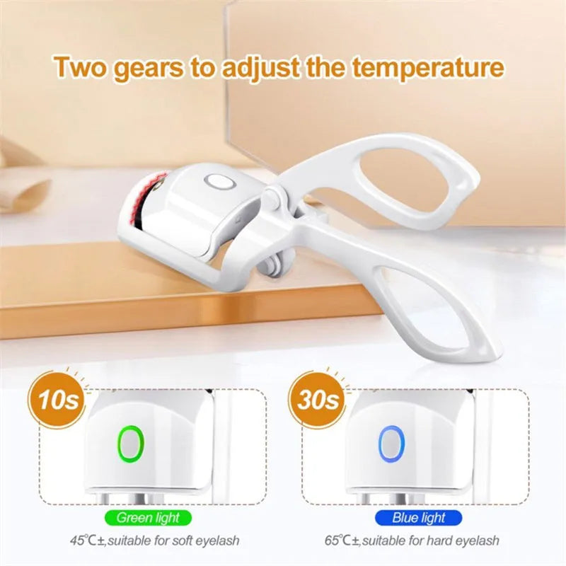 White USB rechargeable heated eyelash curler with a curved design and a small LED light.
