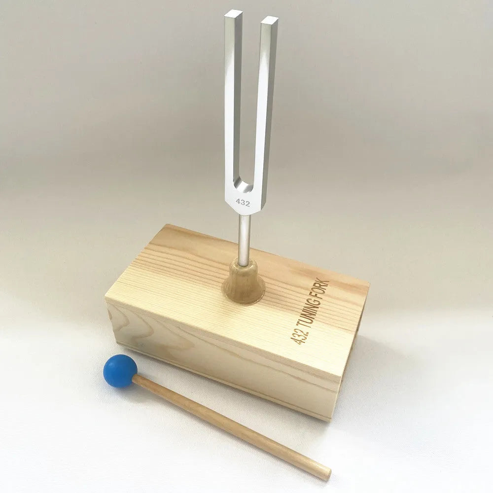 Aluminium alloy 432Hz tuning fork and speaker set on a kraft paper box.