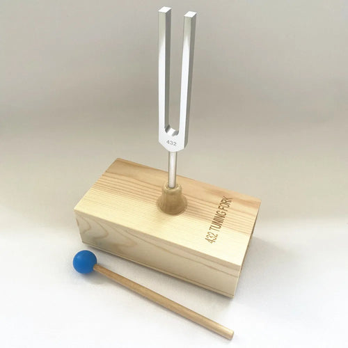 Aluminium alloy 432Hz tuning fork and speaker set on a kraft paper box.