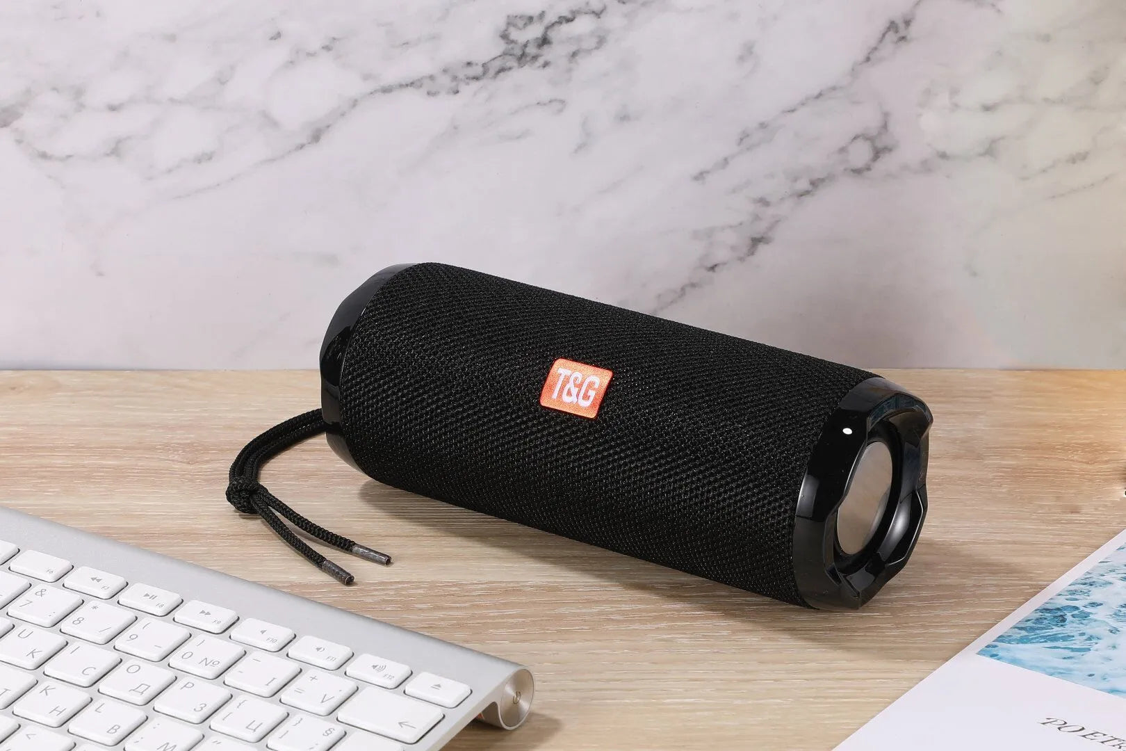 Blue portable Bluetooth speaker with integrated card holder, showing front and side views.