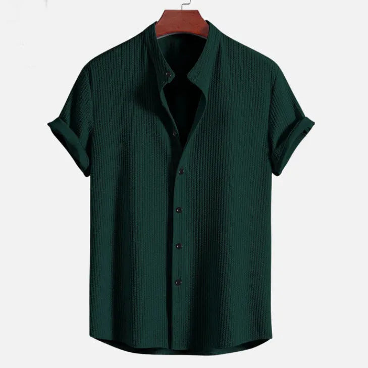 Men's loose-fitting short sleeve shirt in light blue polyester fabric on a hanger.