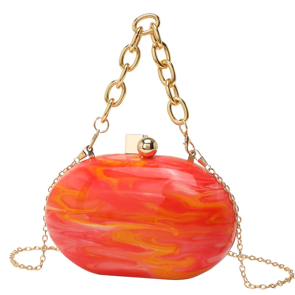 Hard acrylic oval clutch bag with chain strap in a pearlescent colour with phone and file compartments visible.