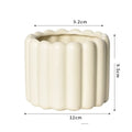 Roman column matte yellow ceramic flower pot on a table.